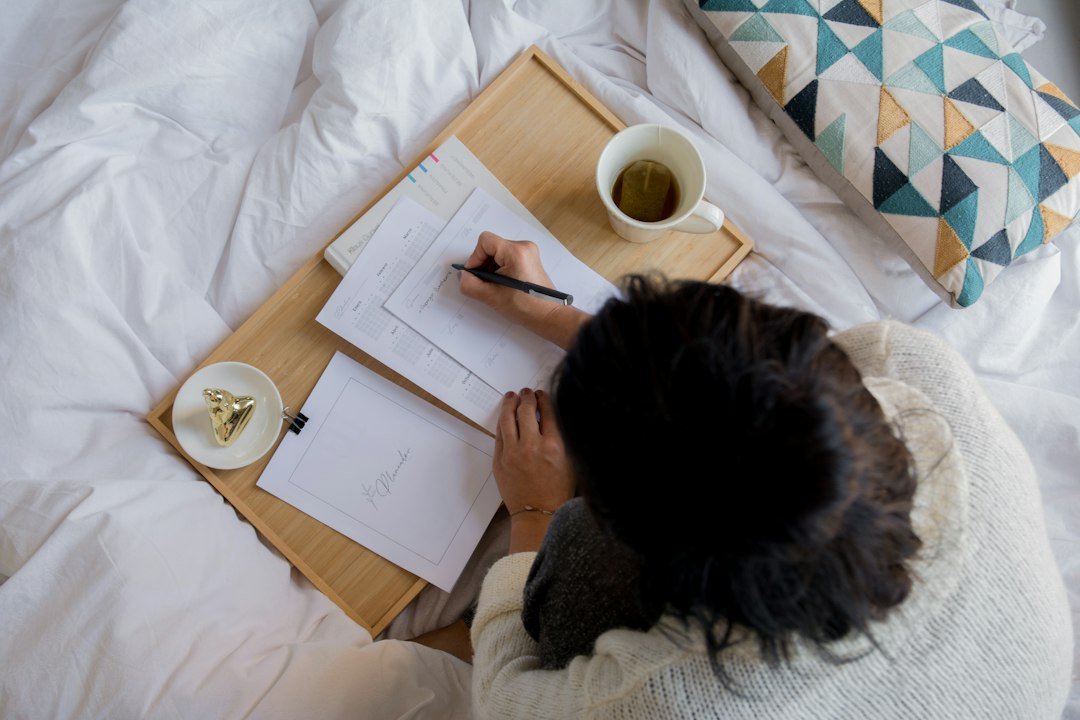Woman recording bladder symptoms in a wellness journal at home